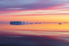 Tabular Icebergs Reflected at Sunrise on the Solstice